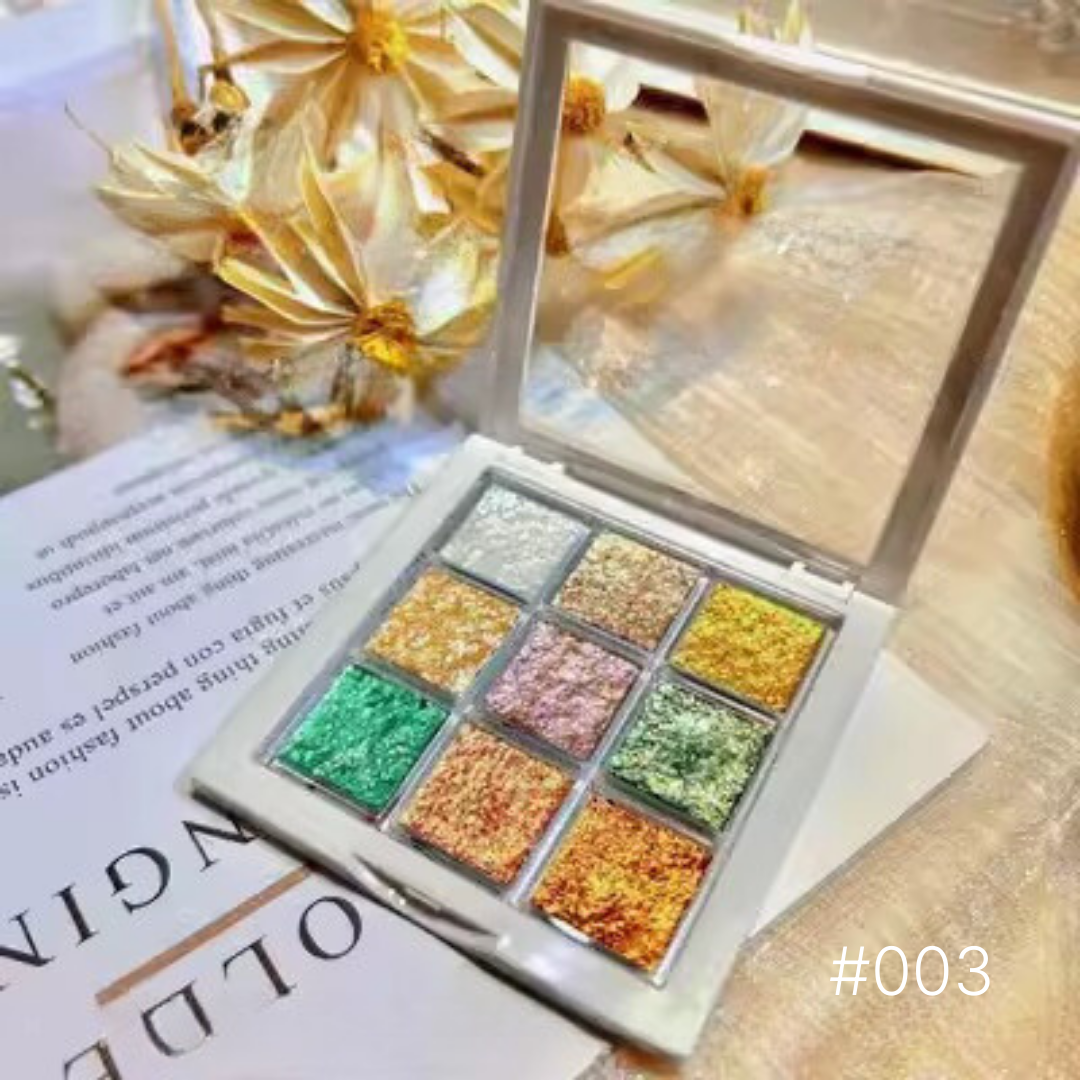 Mocmaki Nail Pigment Palette #003 with glittering gold, green, and red shades, presented on an open book for a luxurious and creative presentation, suitable for sophisticated nail art enthusiasts.