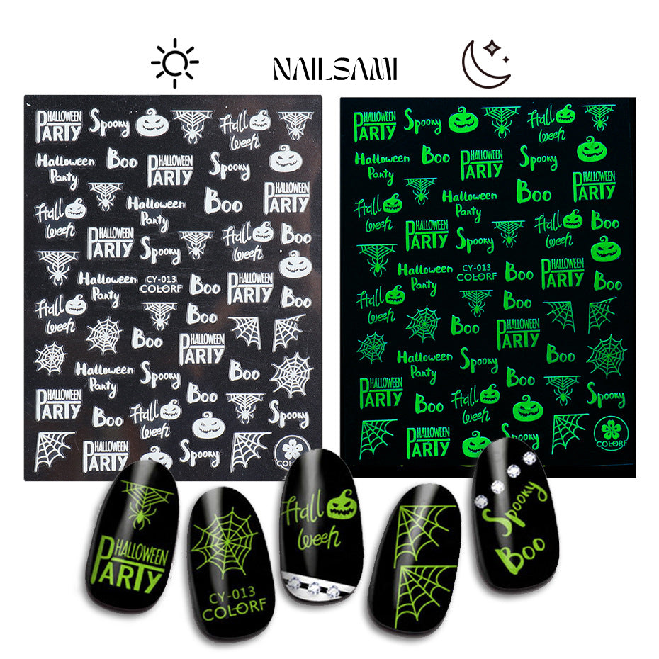 Assorted Halloween nail art stickers from NAILSAMI that glow green, including phrases like "Halloween Party" and spooky elements on a dark sheet.