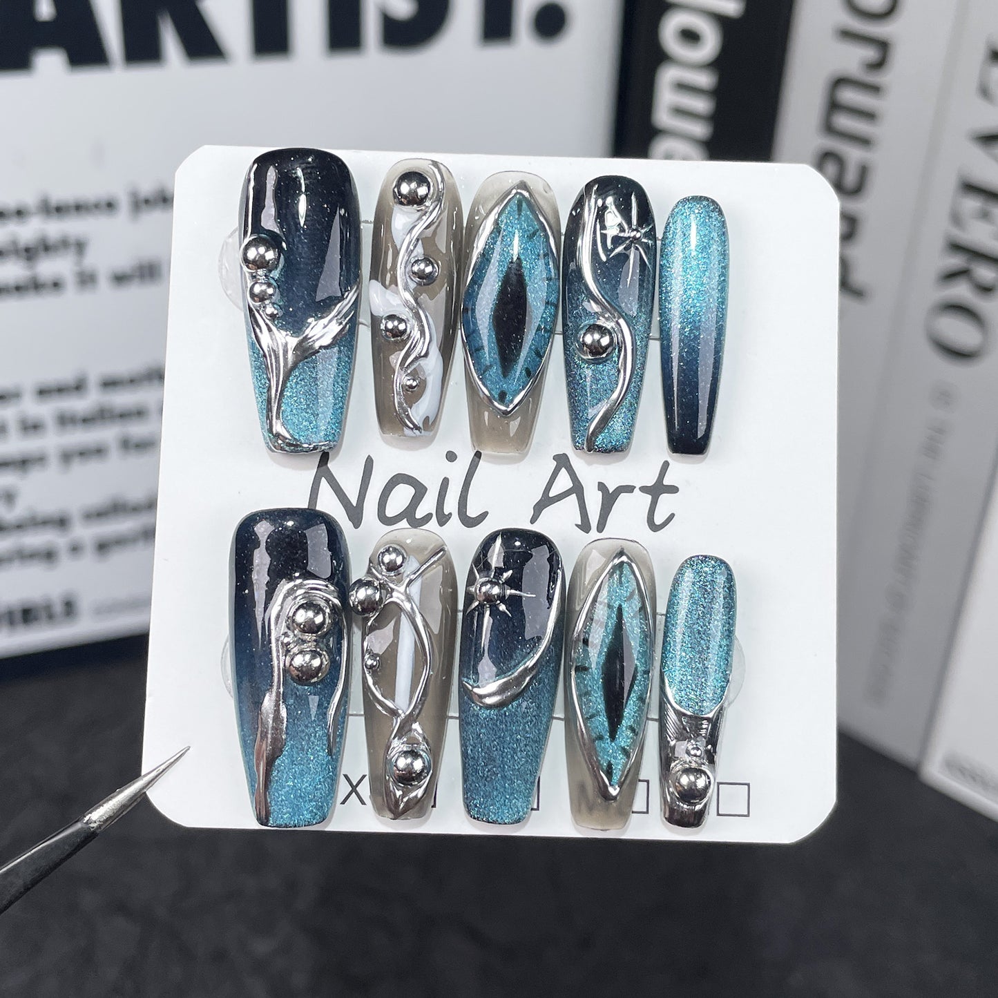 Long metallic blue Halloween nails with geometric and silver details, perfect for cute nail designs