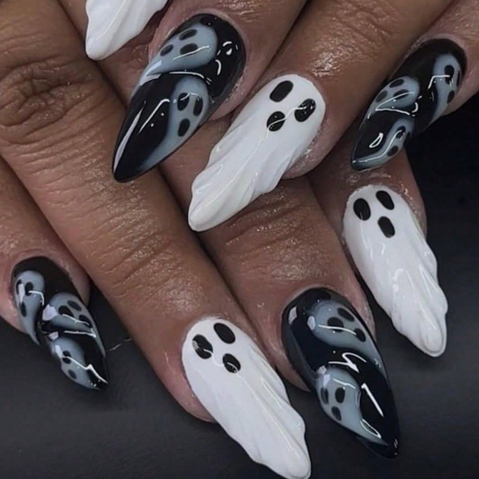 Black and white ghost press-on nails shown on hand with glossy 3D details
