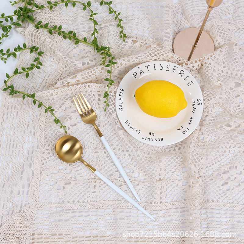 Ivory white floral lace photography backdrop styled with a lemon and tableware