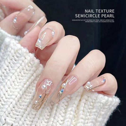 Clear manicure decorated with white resin pearls and small iridescent accents