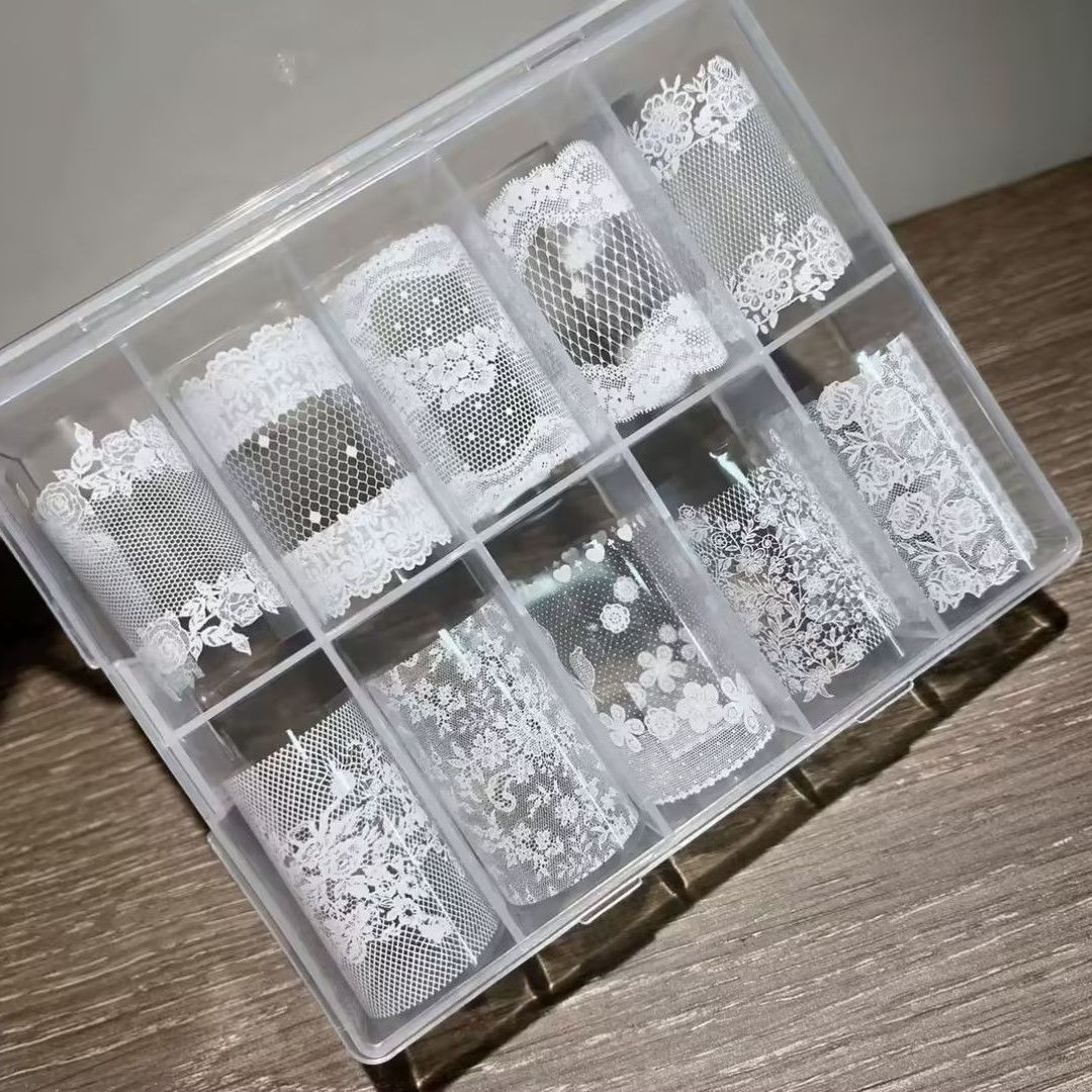 White lace nail transfer foil set with ten assorted patterns in a clear box
