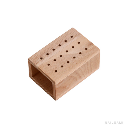 18-hole natural wood nail drill bit holder on a white background