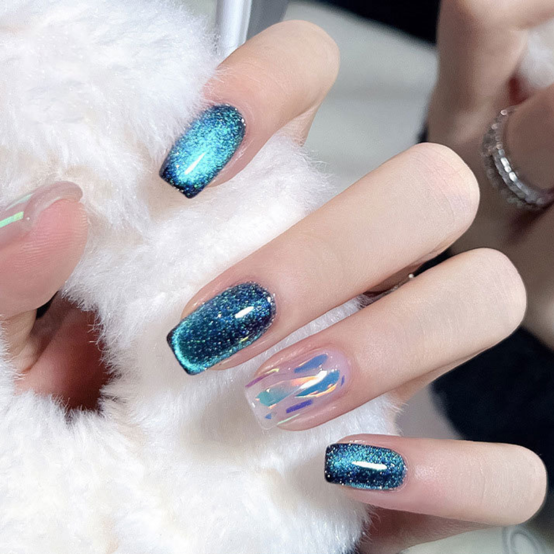 Close-up of nails with a cat eye effect: "Close-up view of fingernails painted with BOMD cat eye gel polish, featuring a mesmerizing magnetic shimmer effect in a deep blue shade."