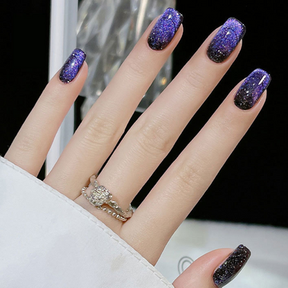 Close-up of nails with a cat eye effect: "Close-up view of fingernails painted with BOMD cat eye gel polish, featuring a mesmerizing magnetic shimmer effect in a deep purple shade."