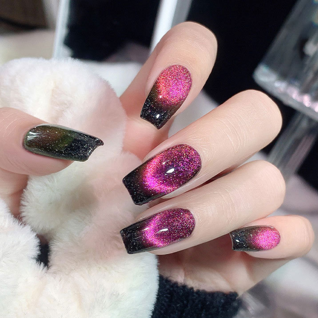 Close-up of nails with a cat eye effect: "Close-up view of fingernails painted with BOMD cat eye gel polish, featuring a mesmerizing magnetic shimmer effect in a deep pink shade."