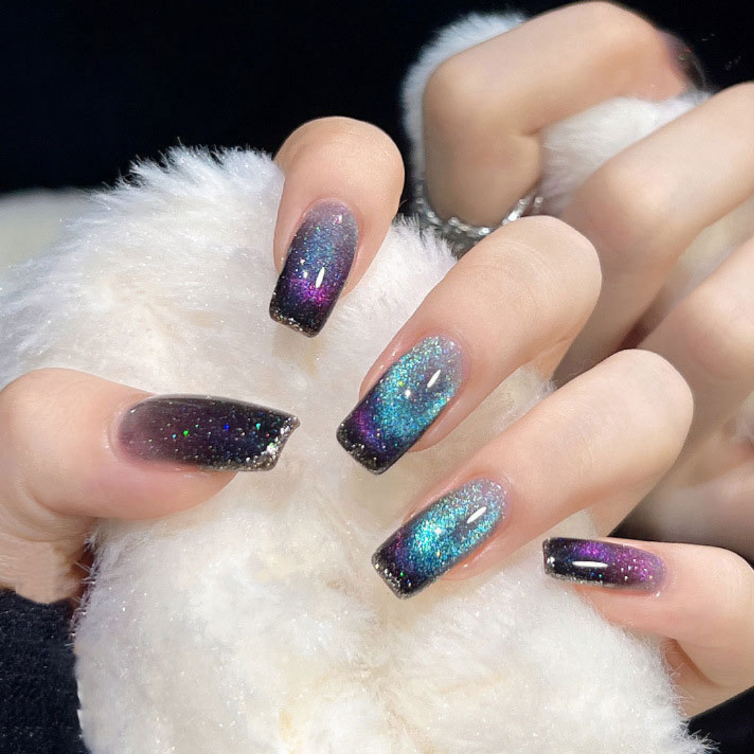 Close-up of nails with a cat eye effect: "Close-up view of fingernails painted with BOMD cat eye gel polish, featuring a mesmerizing magnetic shimmer effect in a bright blue and purple shade."