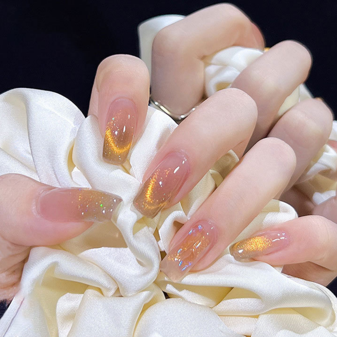 Close-up of nails with a cat eye effect: "Close-up view of fingernails painted with BOMD cat eye gel polish, featuring a mesmerizing magnetic shimmer effect in a gold shade."