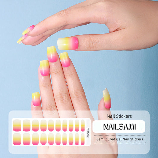 Hand with nails in a bright citrus gradient gel nail sticker design, with a NAILSAMI gel nail sticker sheet displayed below featuring the same orange, yellow, and pink design.