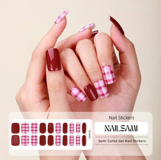 Hand with nails in a warm plaid gel nail sticker design, with a NAILSAMI gel nail sticker sheet displayed below featuring the same plaid pattern.