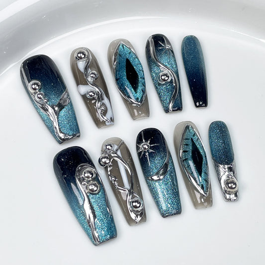 Cute long Halloween nails with metallic blue finish and 3D silver accents