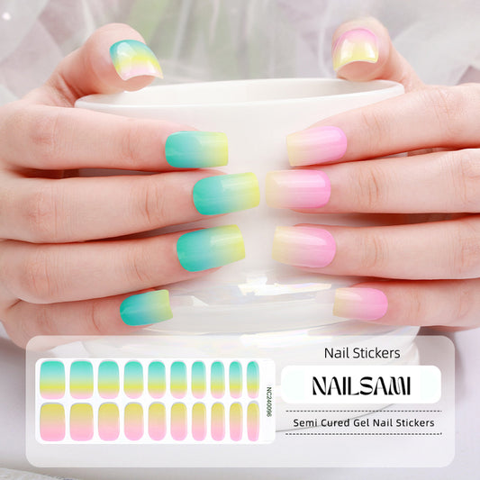 Hand with nails in a pastel rainbow gradient gel nail sticker design, with a NAILSAMI gel nail sticker sheet displayed below featuring the same colorful design.