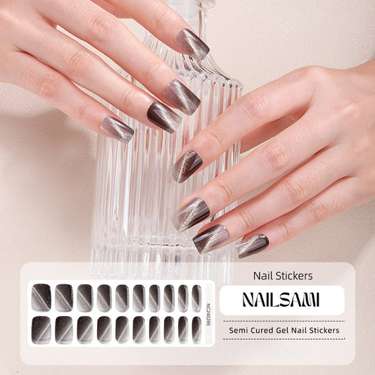 Hand with nails in a bold black marble gel nail sticker design, with a NAILSAMI gel nail sticker sheet displayed below showcasing the same marble design.