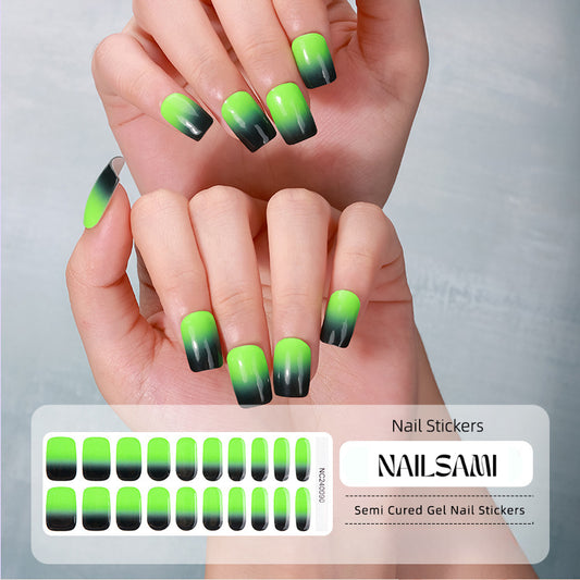 Hand with nails in a vibrant green to black gradient gel nail sticker design, with a NAILSAMI gel nail sticker sheet displayed below showcasing the same green and black design.