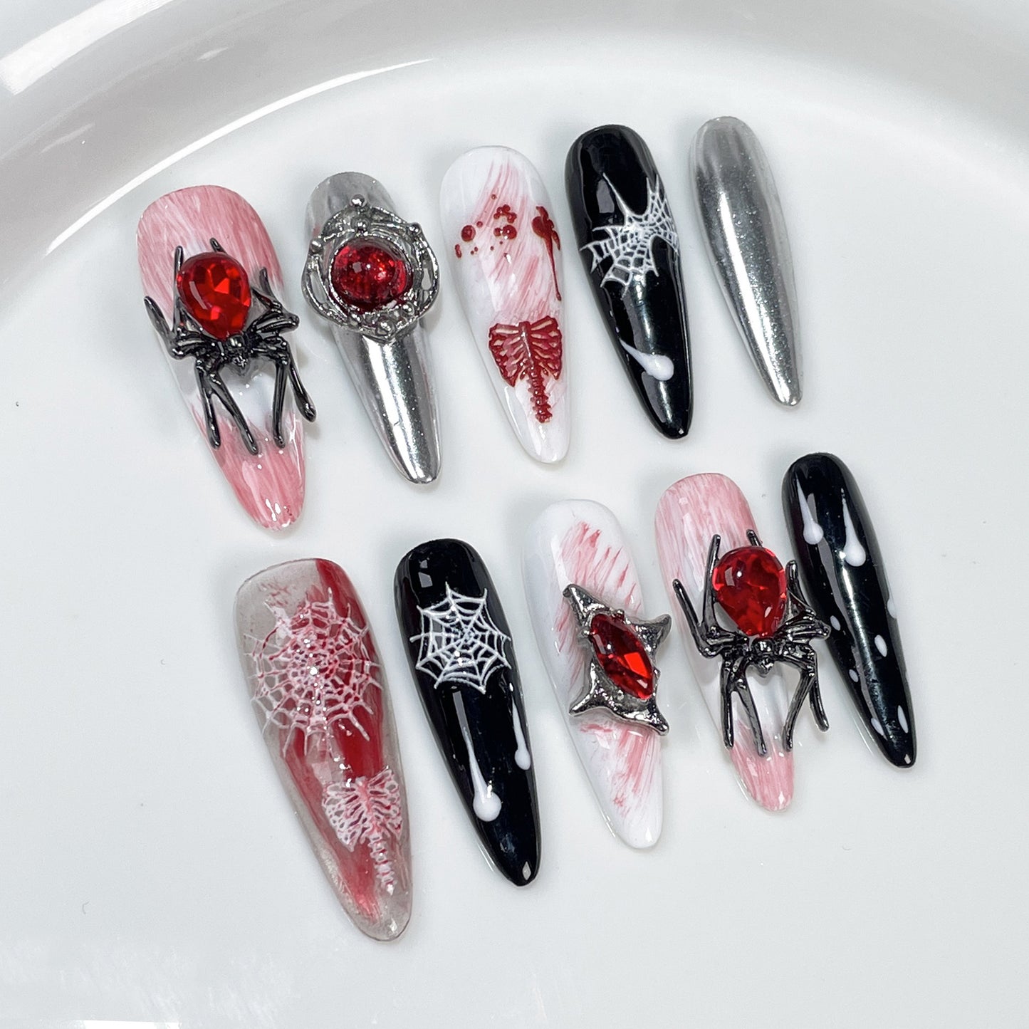 Halloween nails red and black with spider web design and 3D spider charms