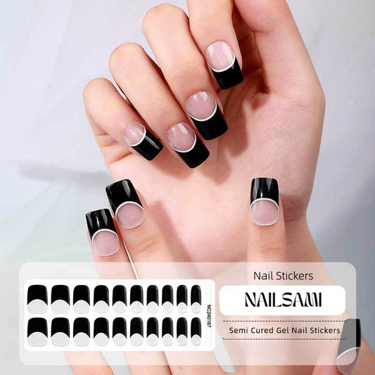 Hand with nails in a bold black French tip gel nail sticker design, with a NAILSAMI gel nail sticker sheet displayed below featuring the same black French tip design.