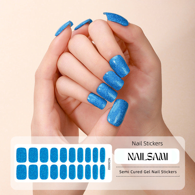 Hand with nails decorated in a vibrant blue glitter gel nail sticker design, with a NAILSAMI gel nail sticker sheet displayed below featuring the same blue glitter design.