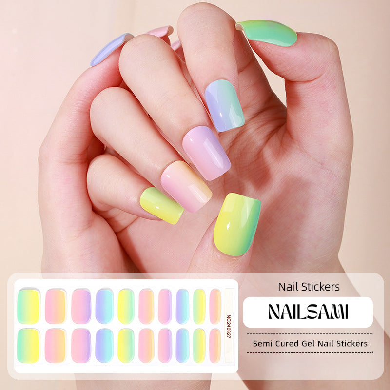 Hand with nails in a soft pastel rainbow gel nail sticker design, with a NAILSAMI gel nail sticker sheet displayed below showcasing the same rainbow design.