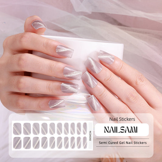 Hand with nails featuring an elegant silver shimmer gel nail sticker design, with a NAILSAMI gel nail sticker sheet displayed below showcasing the same silver design.