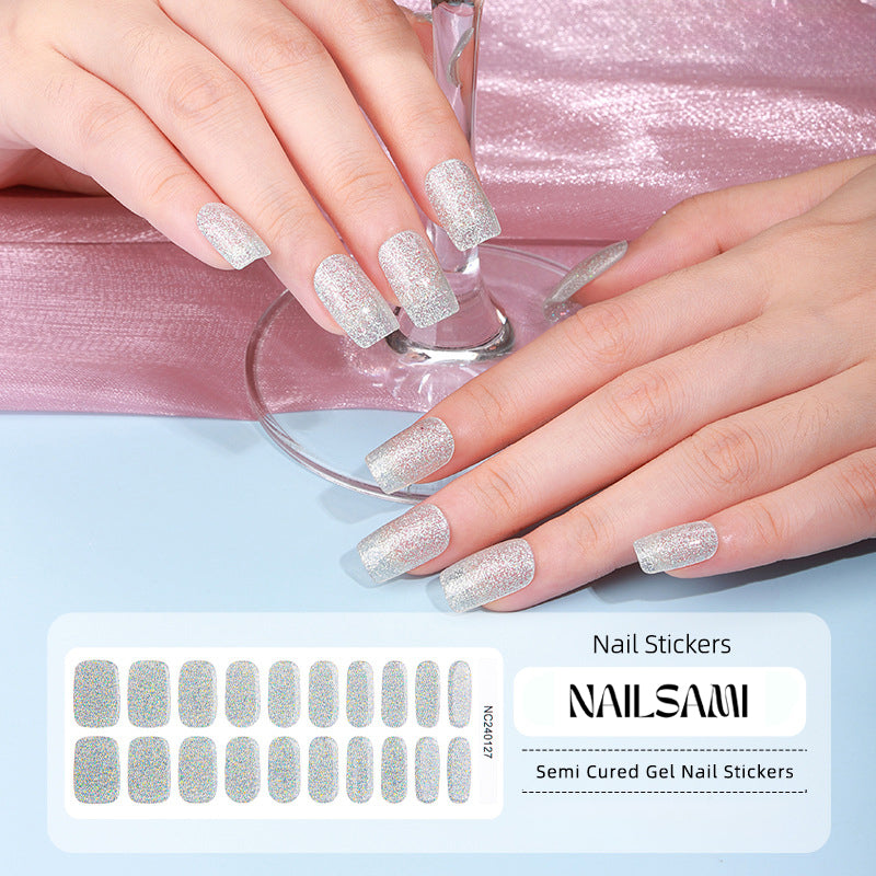 Hand with nails in a glittery silver gel nail sticker design, with a NAILSAMI gel nail sticker sheet displayed below featuring the same silver glitter design.