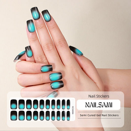 Hand with nails in a deep teal to black gradient gel nail sticker design, with a NAILSAMI gel nail sticker sheet displayed below featuring the same teal and black design.