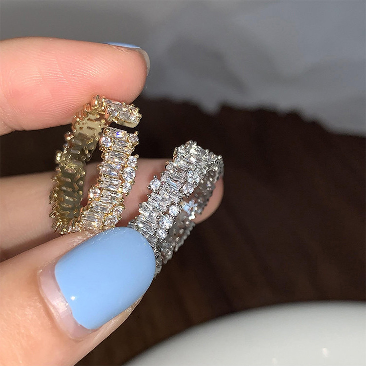 Gold-tone and silver-tone zircon-set adjustable rings held together