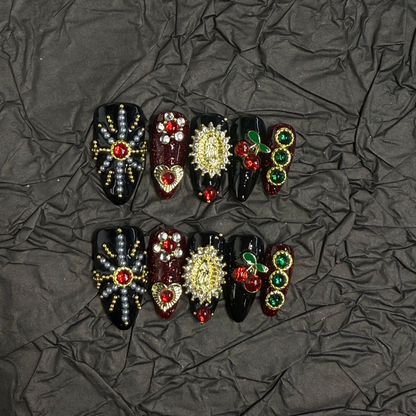 Full black and burgundy medium almond press-on nail design with red and green accents