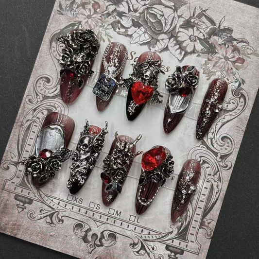 Burgundy gothic press-on nail set with silver-tone skulls, roses and red accents