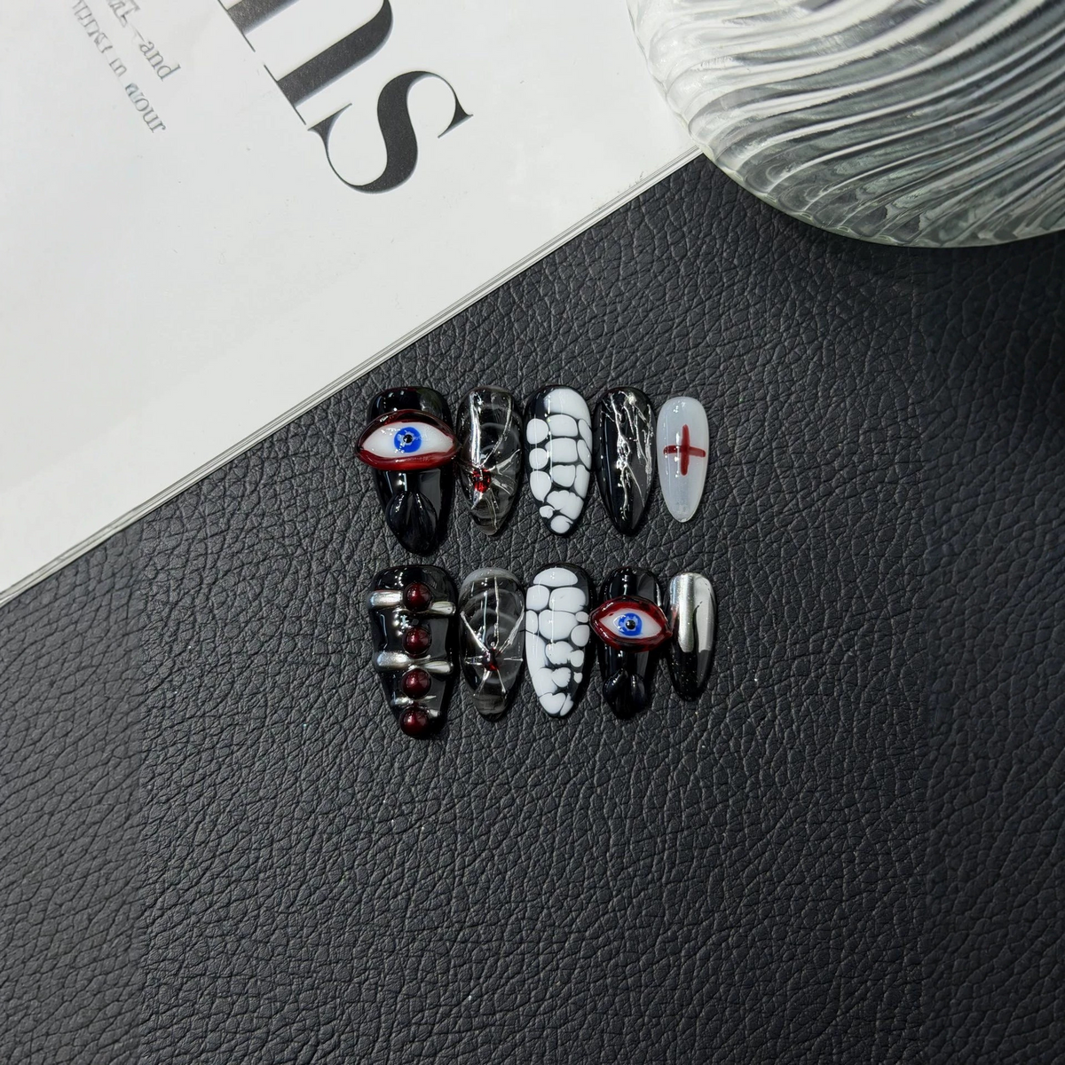 Gothic almond press-on nail set with eye motifs, red crosses and silver-tone accents