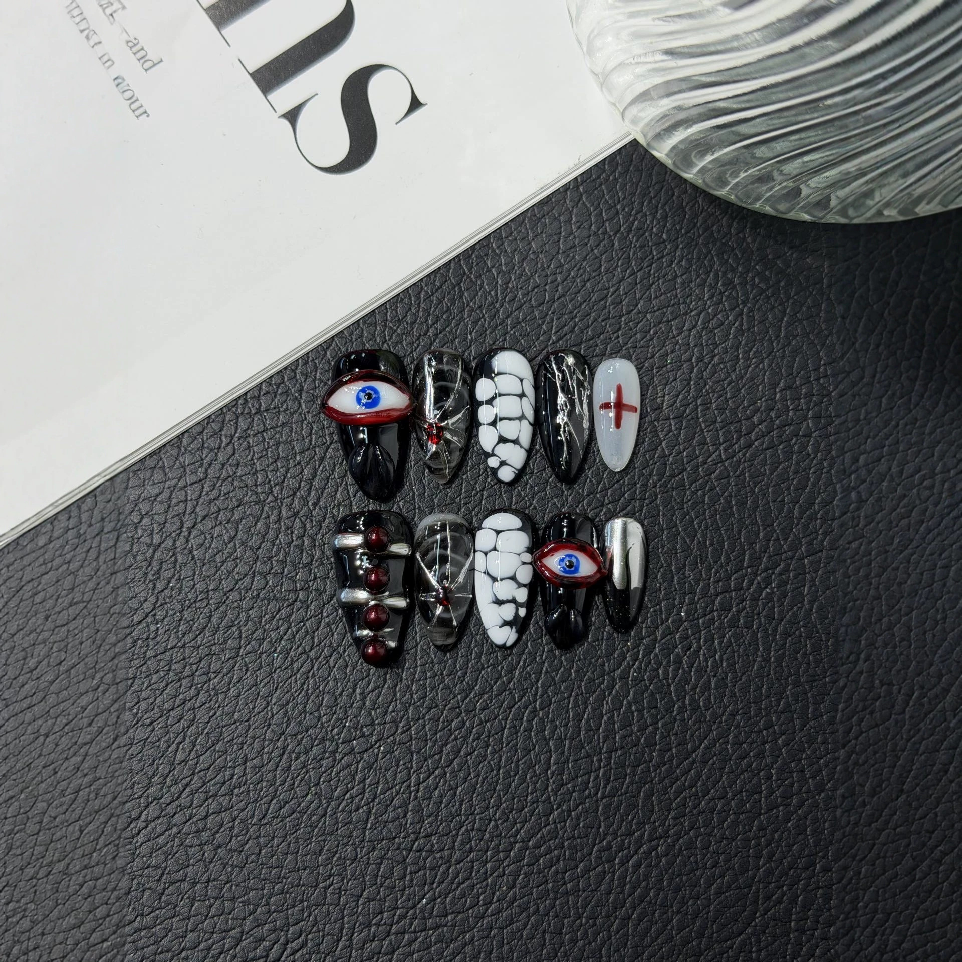 Gothic almond press-on nail set with eye motifs, red crosses and silver-tone accents