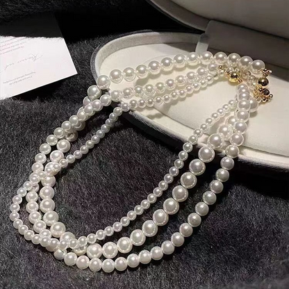 White pearl-style bead necklaces in several bead sizes