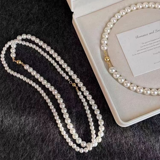 White pearl-style bead necklaces with gold-tone lobster clasps
