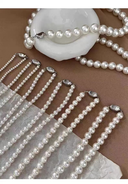 White pearl-style bead necklaces with silver-tone oval clasps