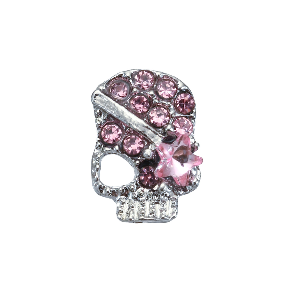 Close-up of a silver-tone gothic skull nail charm with pink rhinestones and star accent