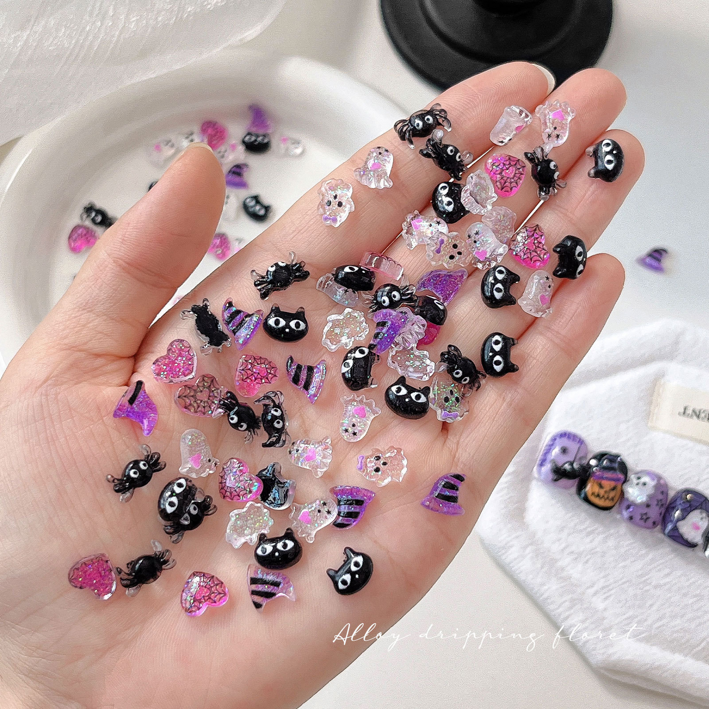 Small Halloween jelly resin nail charms shown in a hand for scale
