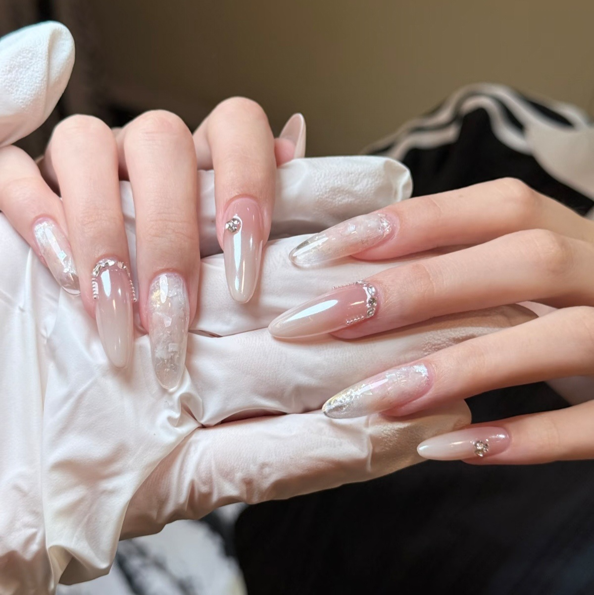 Iridescent silver flake long almond press-on nails in sheer nude and milky white