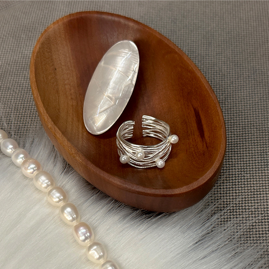 Irregular multi-layer pearl open ring displayed in a wooden styling dish