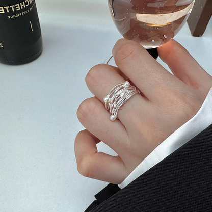 Pearl-accented open ring worn with black and white styling