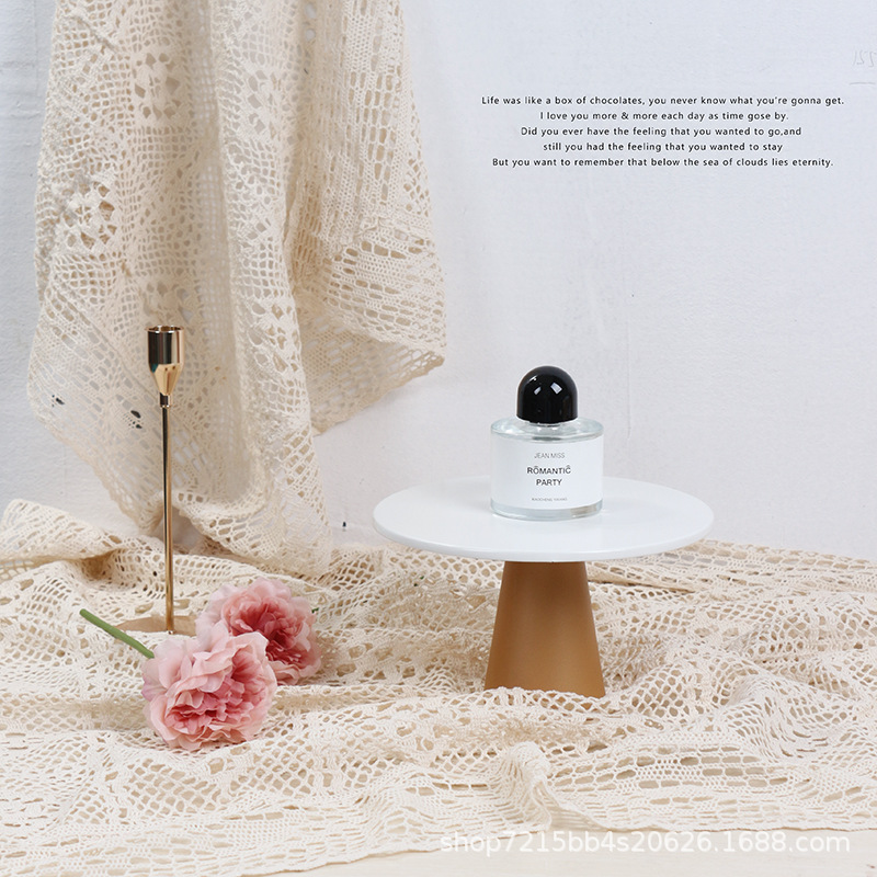 Ivory white cotton lace backdrop styled for perfume product photography