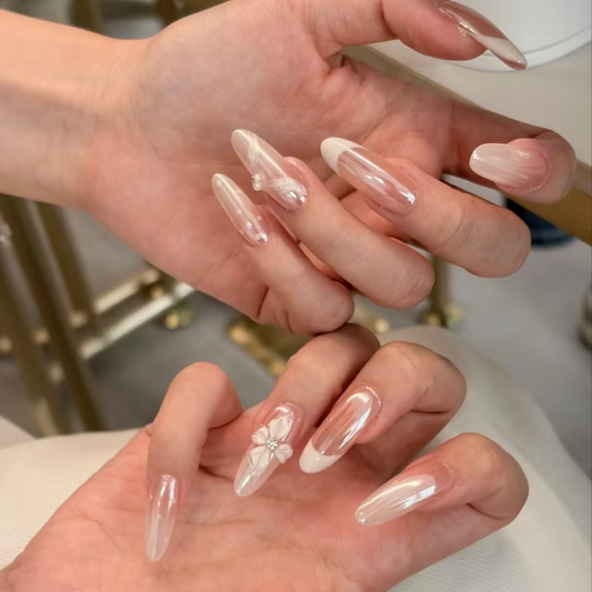 Moonlight pink long almond press-on nails with white French tips and floral accents