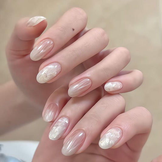 Moonlight pink oval press-on nails with glossy nude and iridescent shell accents