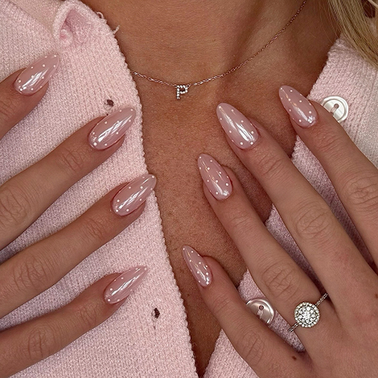 Pearlescent blush pink almond press-on nails with small white polka dots