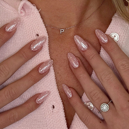 Pearlescent blush pink almond press-on nails with small white polka dots