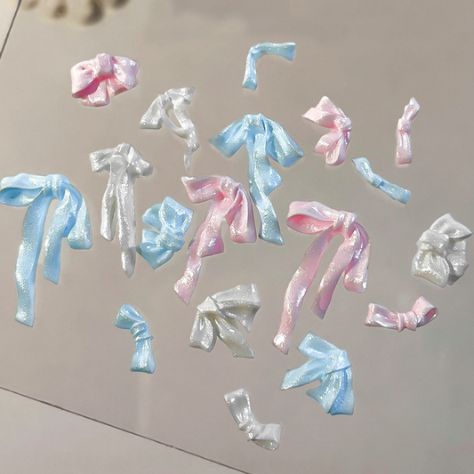 Assorted pink, blue and white pearlescent resin bow nail decorations