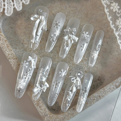 Silver and white manicure featuring pearl white resin bow decorations