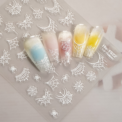 Redanco HE-1922 white embossed spider web stickers on pastel manicure examples