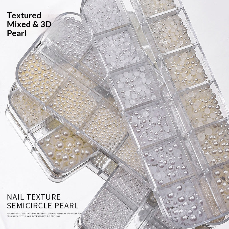 Assorted white and ivory resin pearl nail art decorations in clear boxes