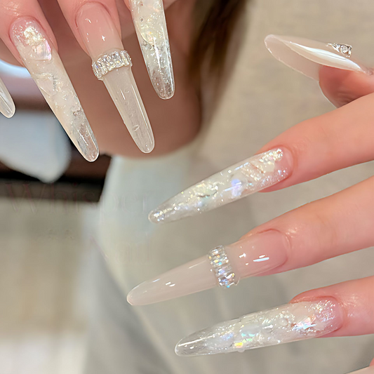 Long grey-beige press-on nails with iridescent shell flakes and silver bands