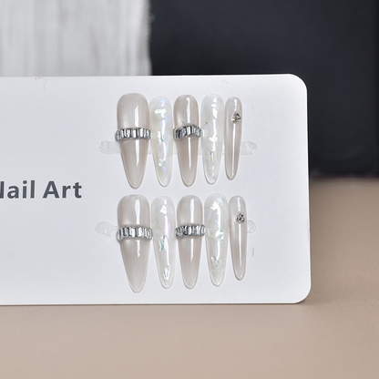 SG747 press-on nail set displayed with grey-beige, shell and silver band designs